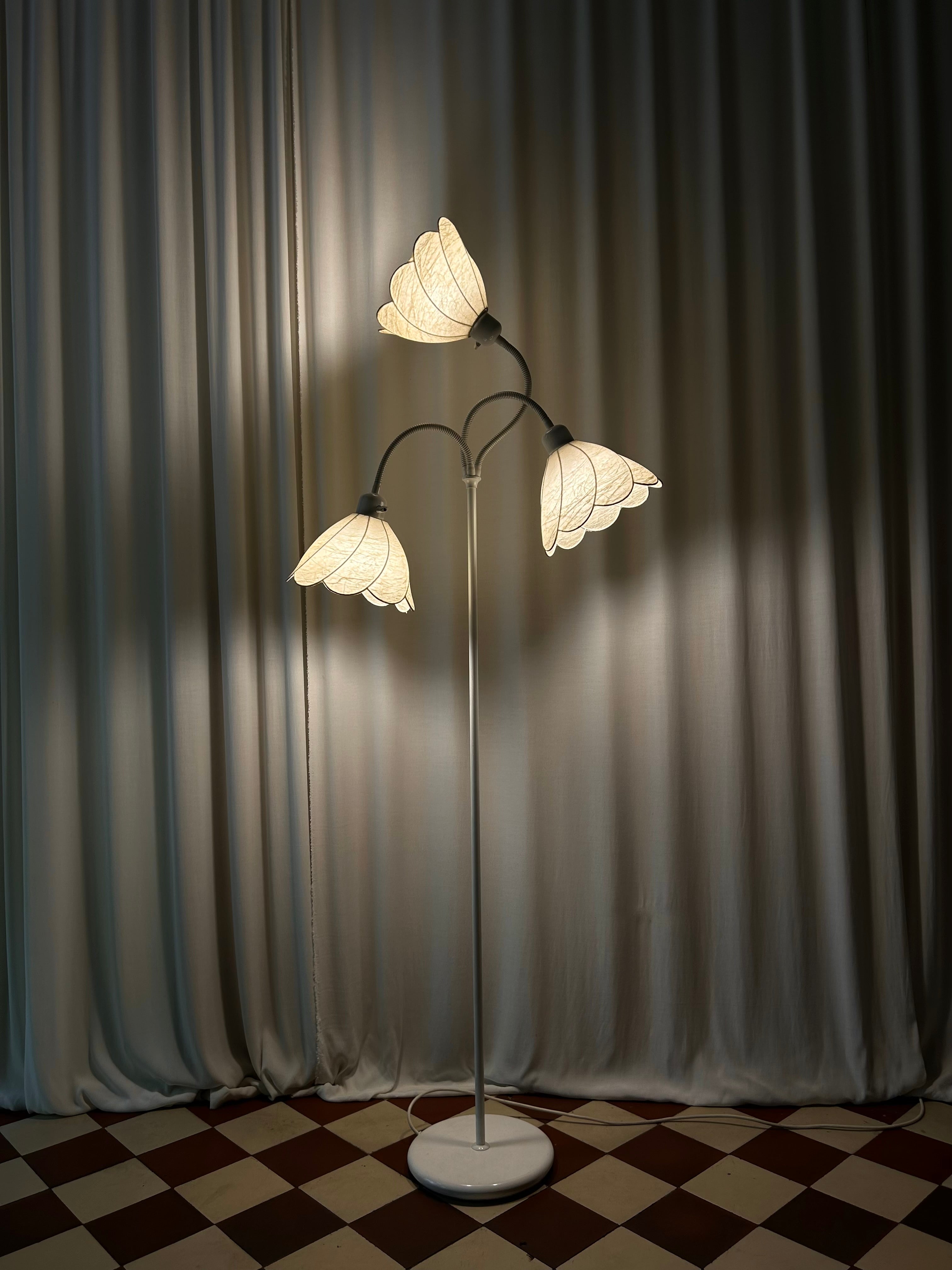 Egon Hillebrand three-arm floor lamp, front view, lit in dark room setting