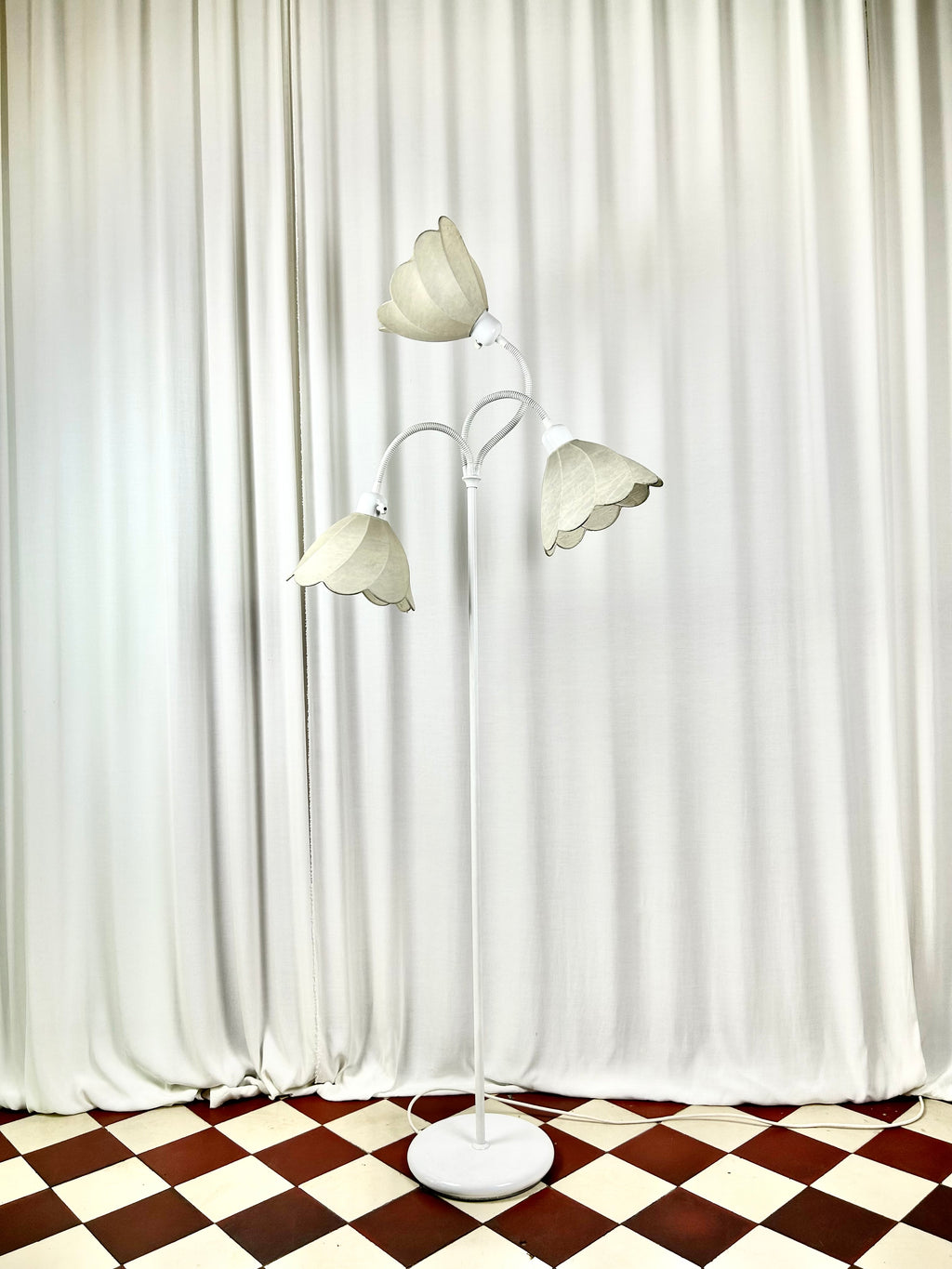 Egon Hillebrand three-arm floor lamp, front view, unlit in bright room setting