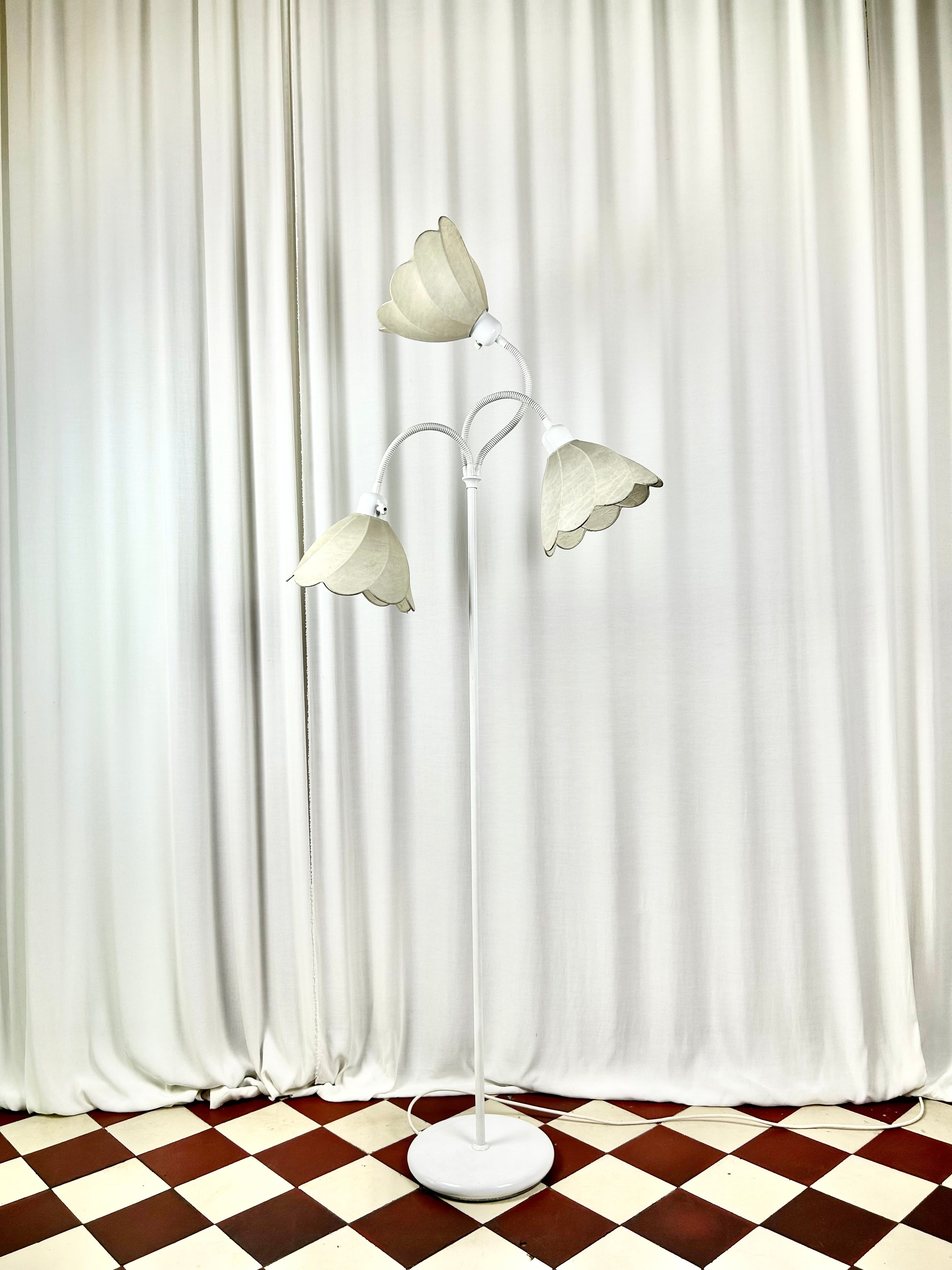 Egon Hillebrand three-arm floor lamp, front view, unlit in bright room setting