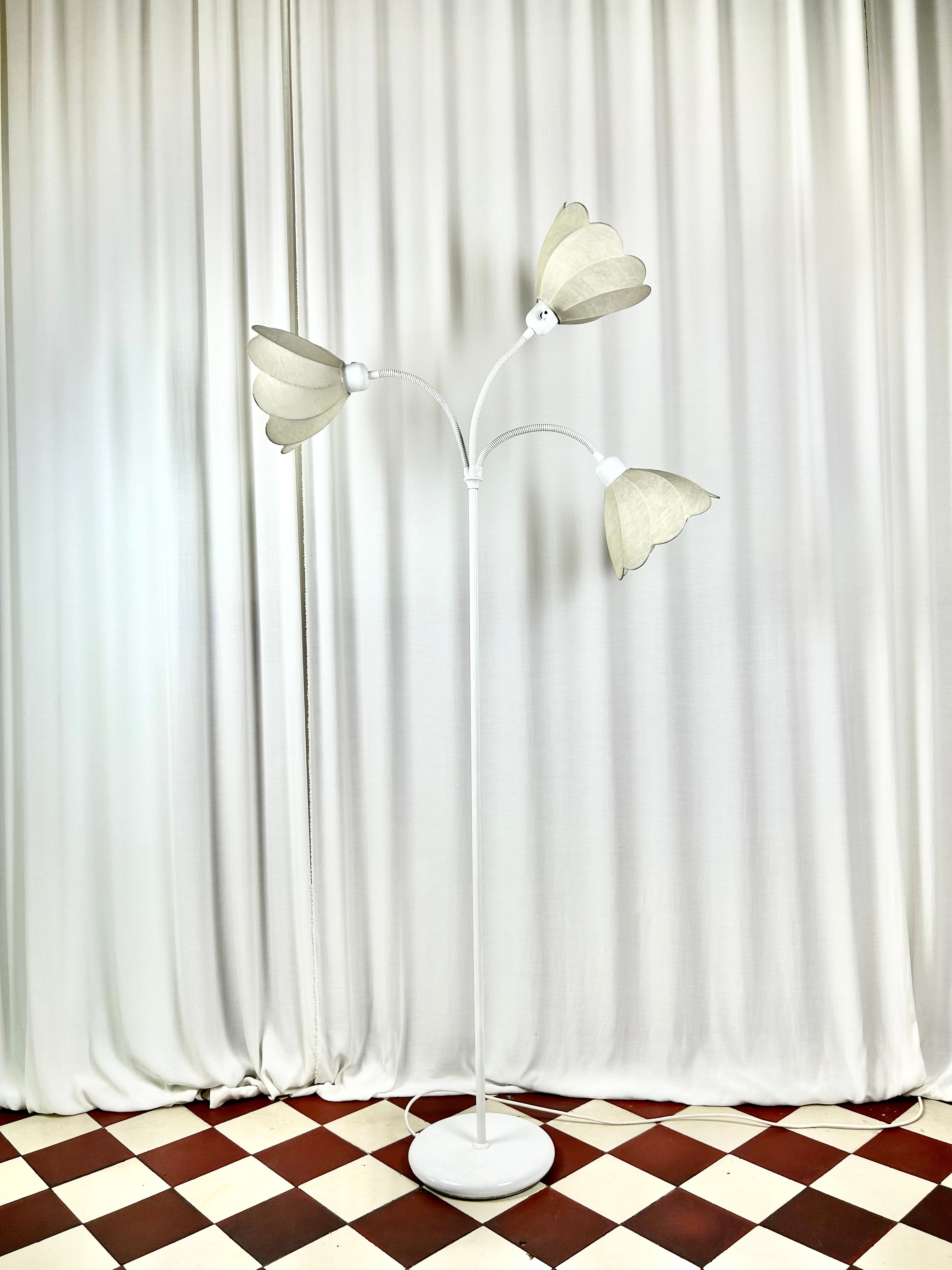 gon Hillebrand three-arm floor lamp, front view, unlit in bright room setting