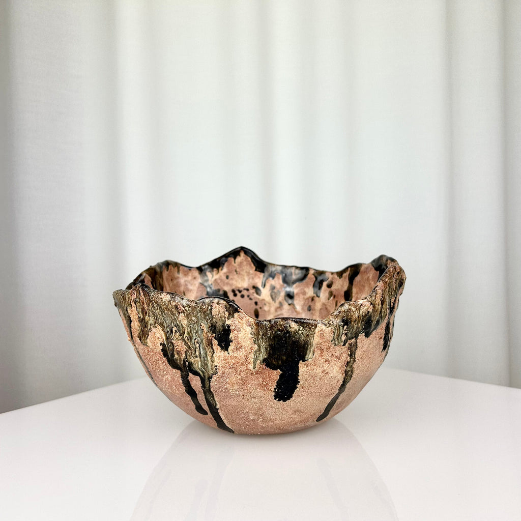 Vintage handmade ceramic bowl with irregular rim