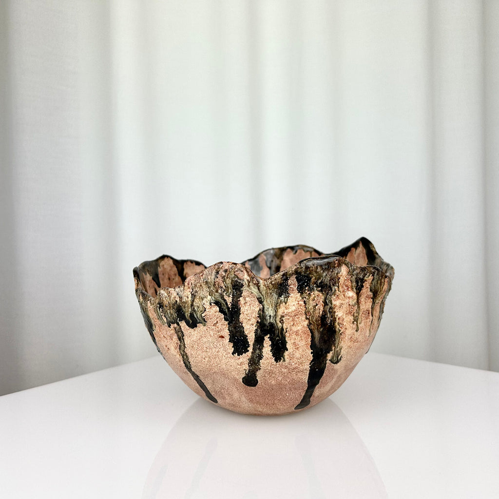 Vintage handmade ceramic bowl with irregular rim