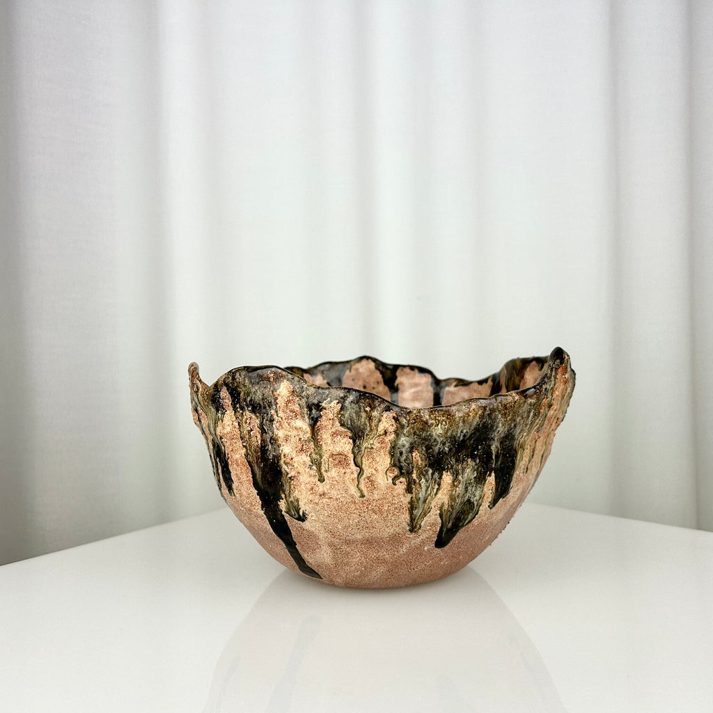 Vintage handmade ceramic bowl with irregular rim