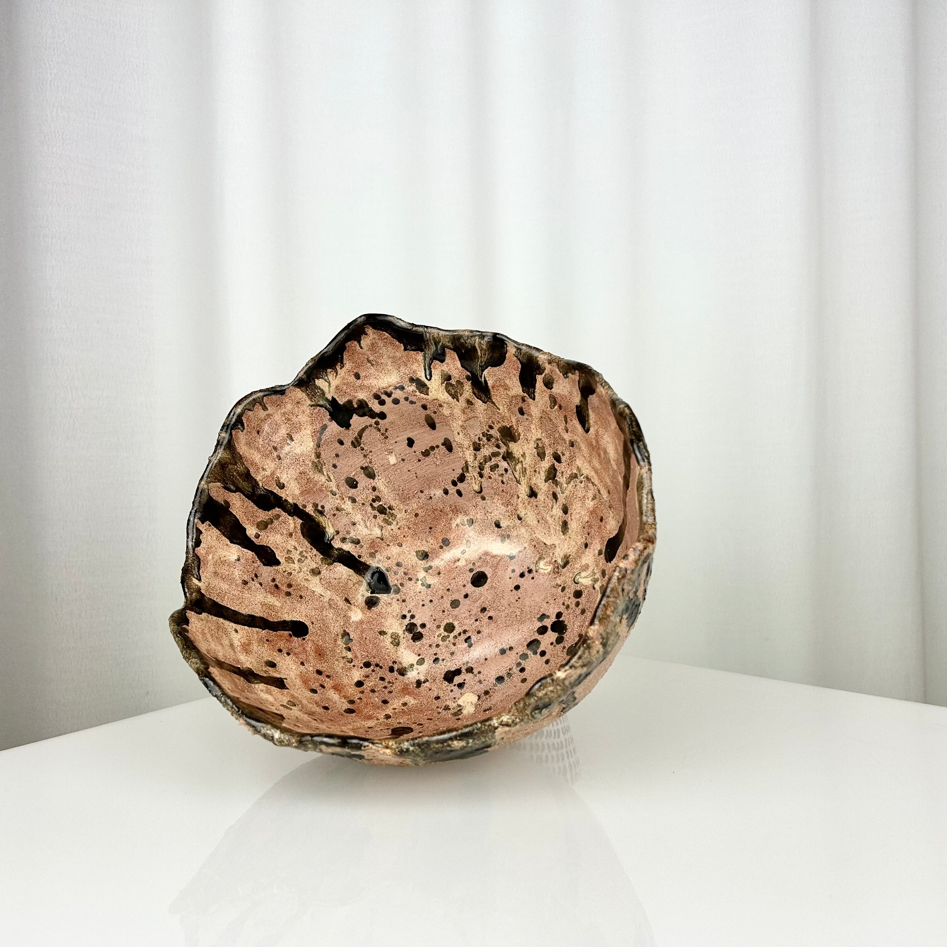 Vintage handmade ceramic bowl with irregular rim, inside