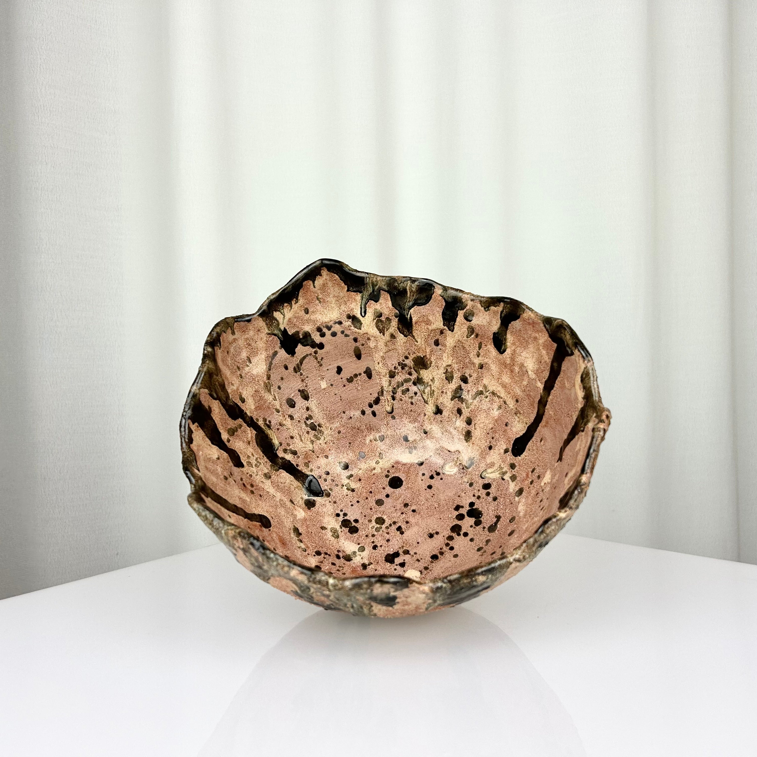 Vintage handmade ceramic bowl with irregular rim, inside