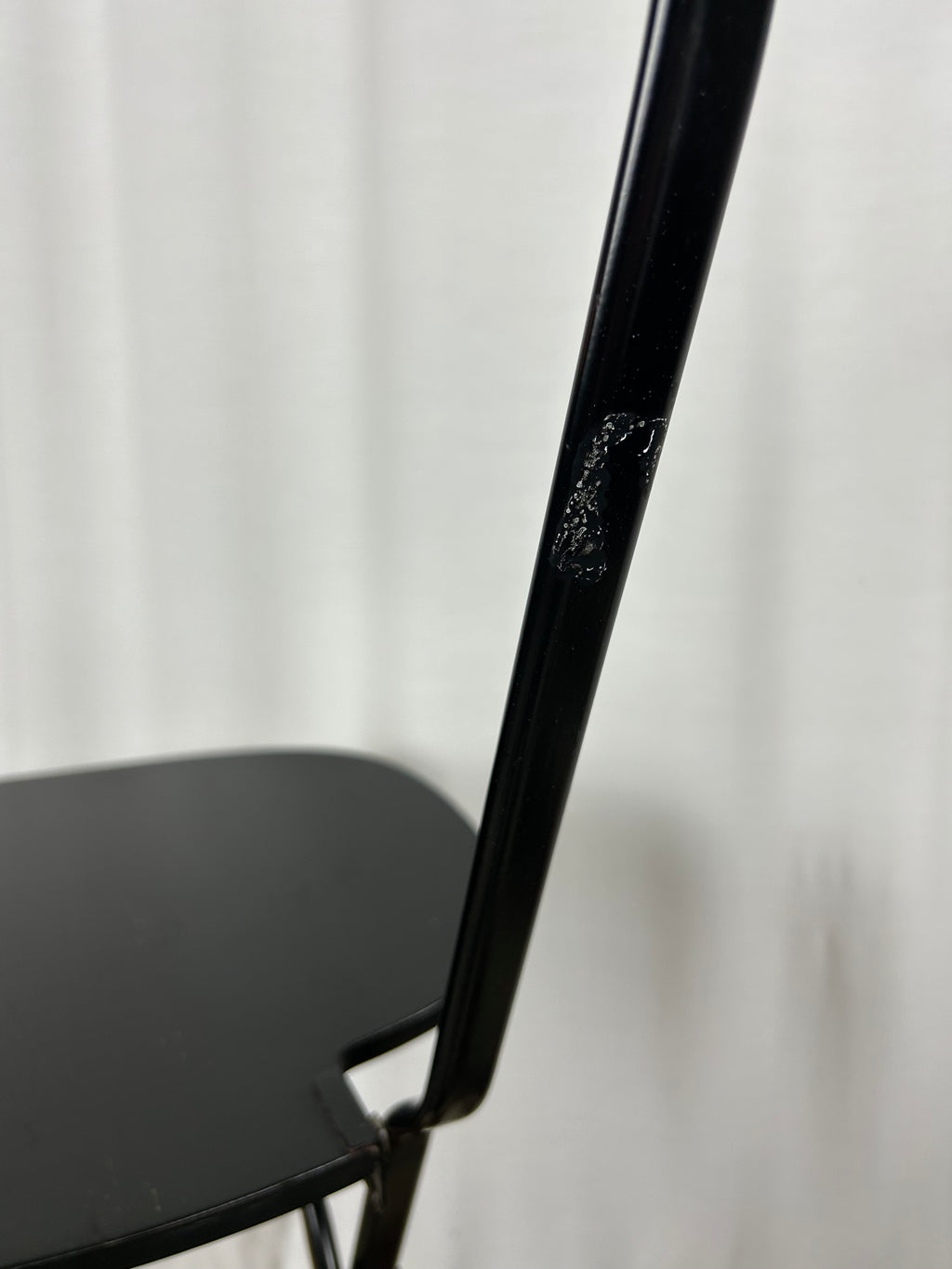 Two black foldable "Dafne" chairs by Gastone Rinaldi for the Italian manufacturer Thema, closeup