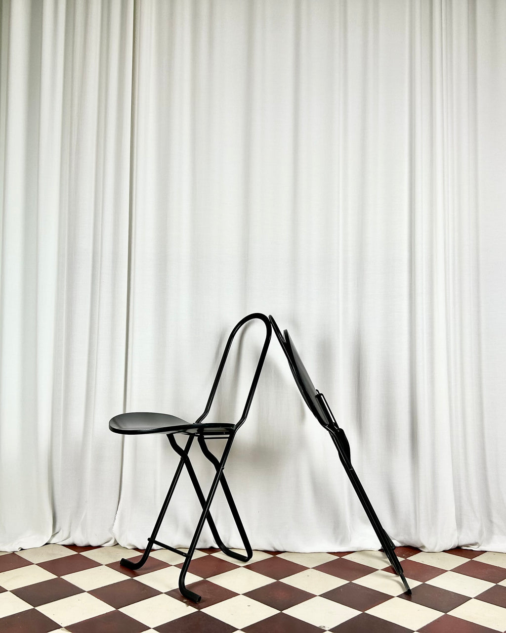 Two black foldable "Dafne" chairs by Gastone Rinaldi for the Italian manufacturer Thema, one chair folded