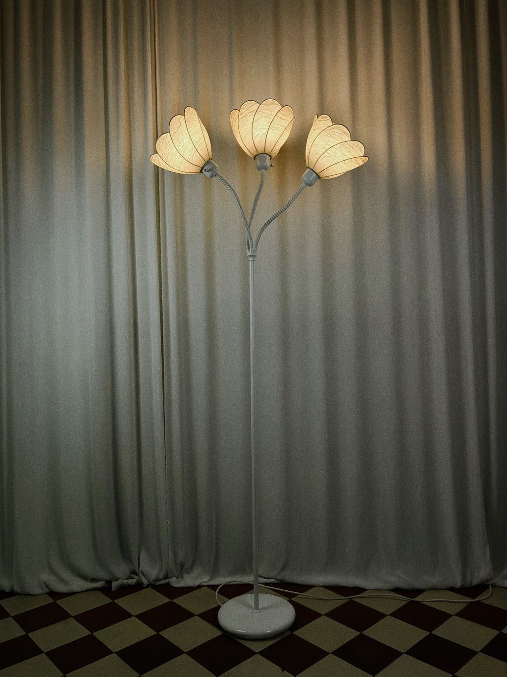 gon Hillebrand three-arm floor lamp, front view, illuminated in dark setting