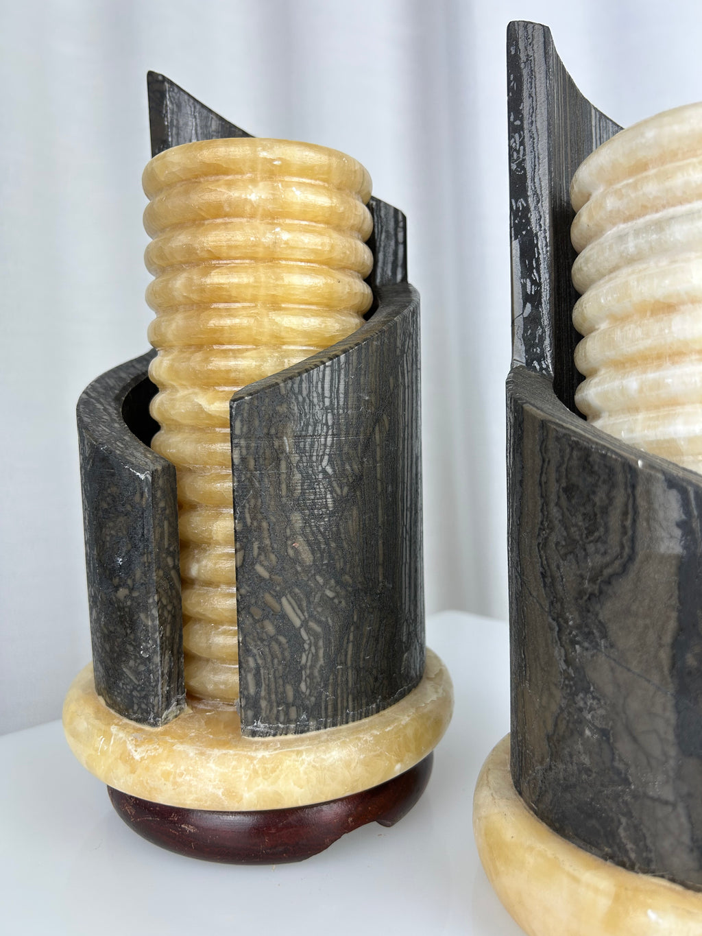 A pair of postmodern table lamps made of solid dark marble with fluted internal alabaster columns.