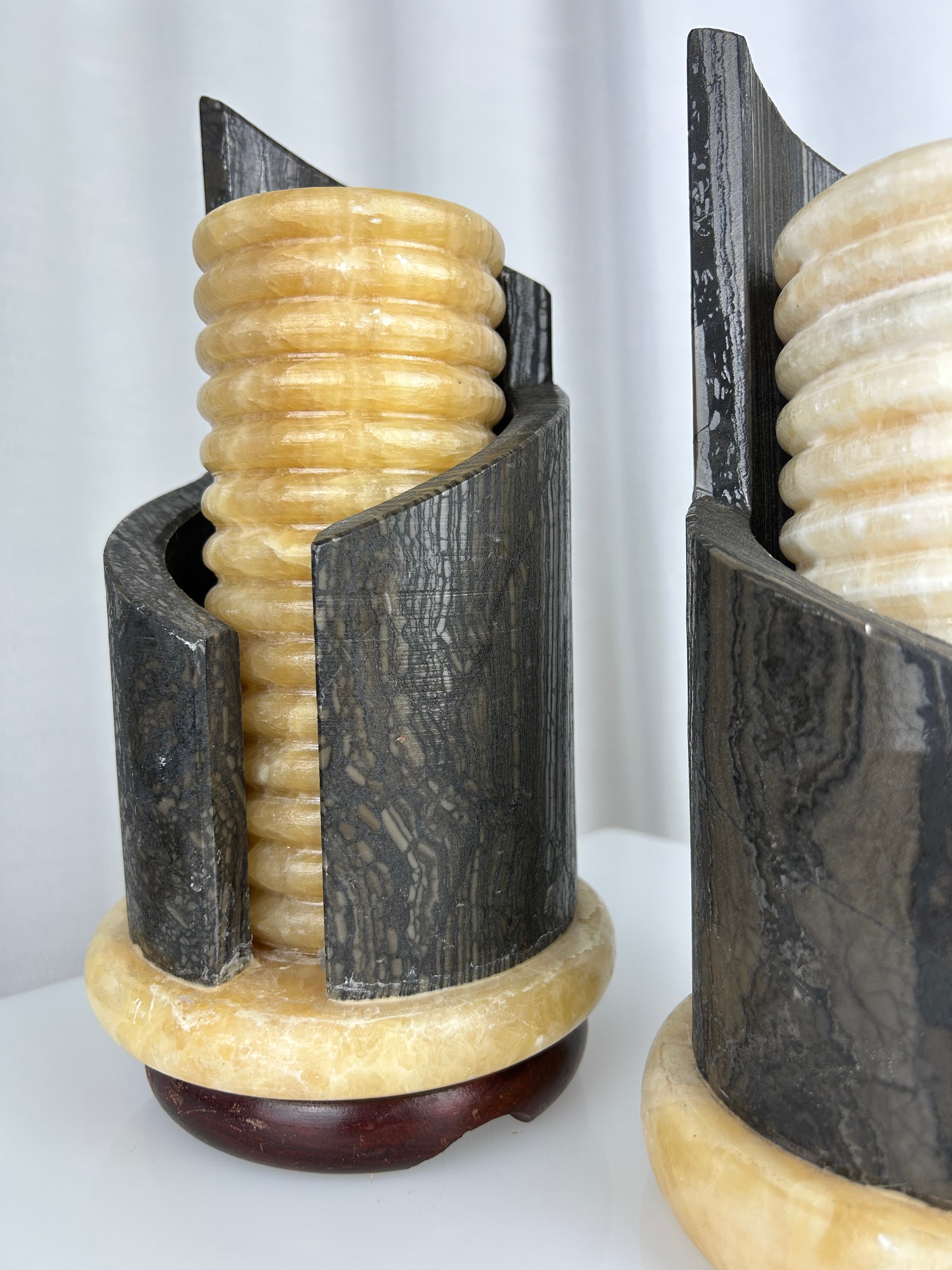 A pair of postmodern table lamps made of solid dark marble with fluted internal alabaster columns.