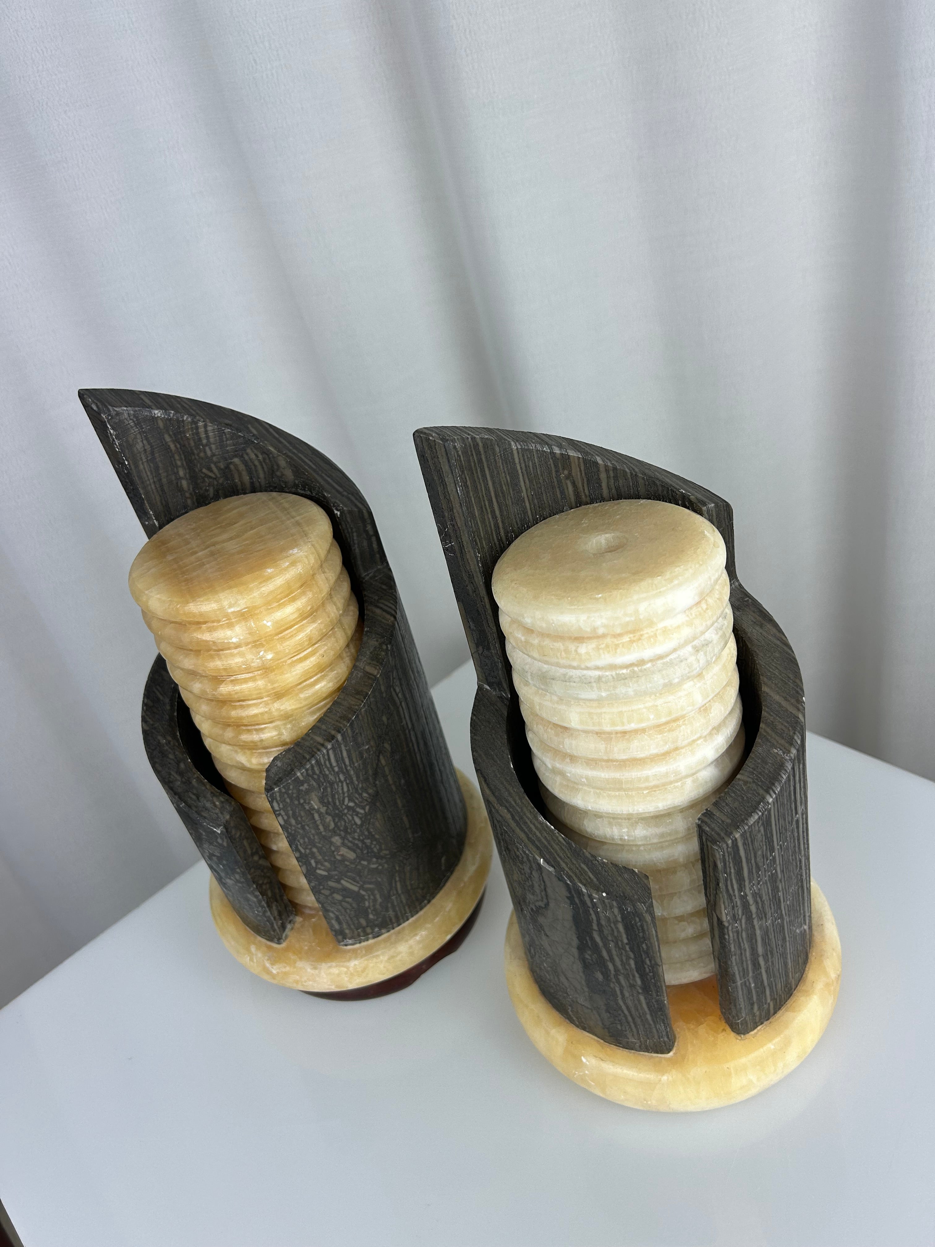 A pair of postmodern table lamps made of solid dark marble with fluted internal alabaster columns.