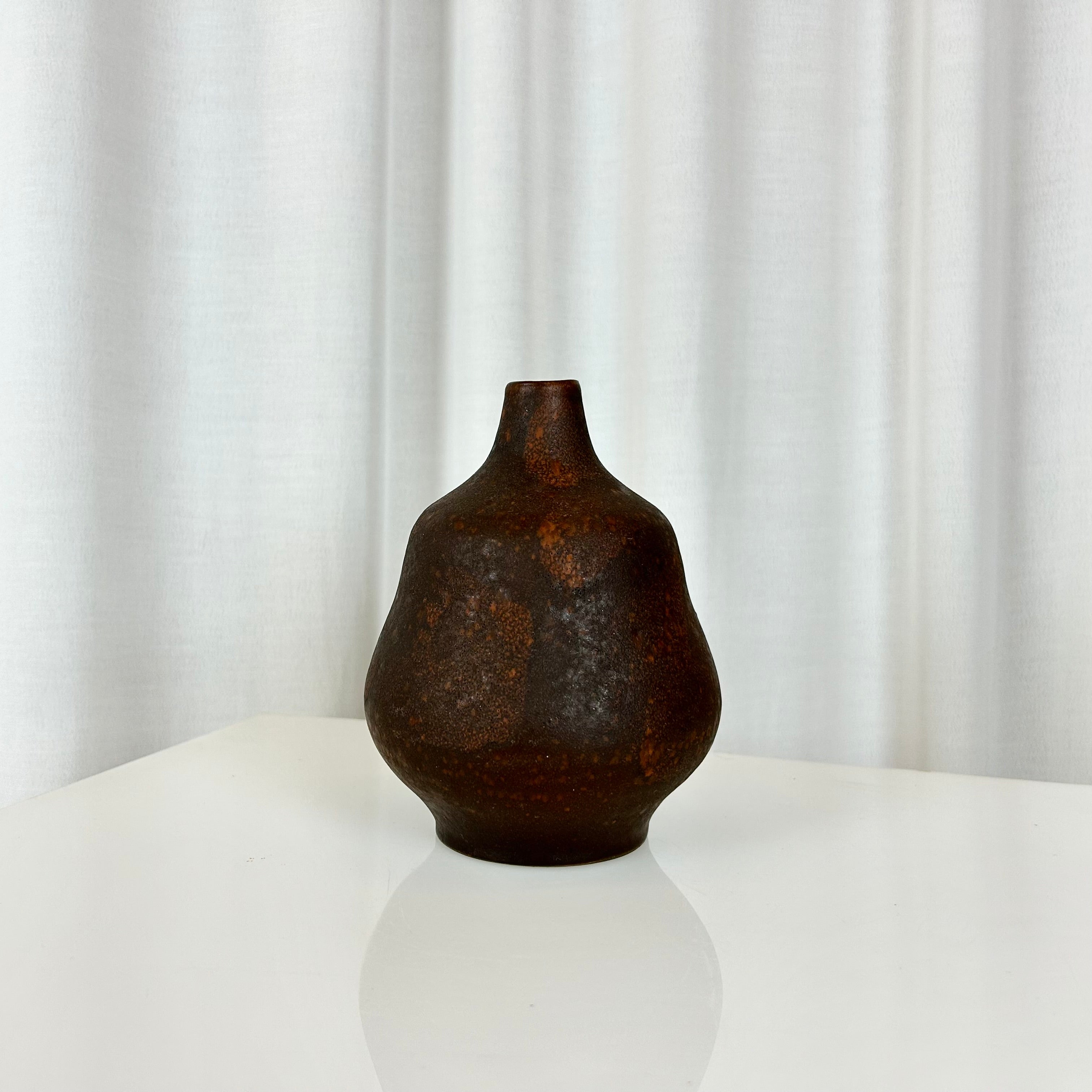 Small sculptural ceramic vase. Handmade, signed on the base, with organic rounded form and warm earthy glaze. A compact yet striking decorative piece.