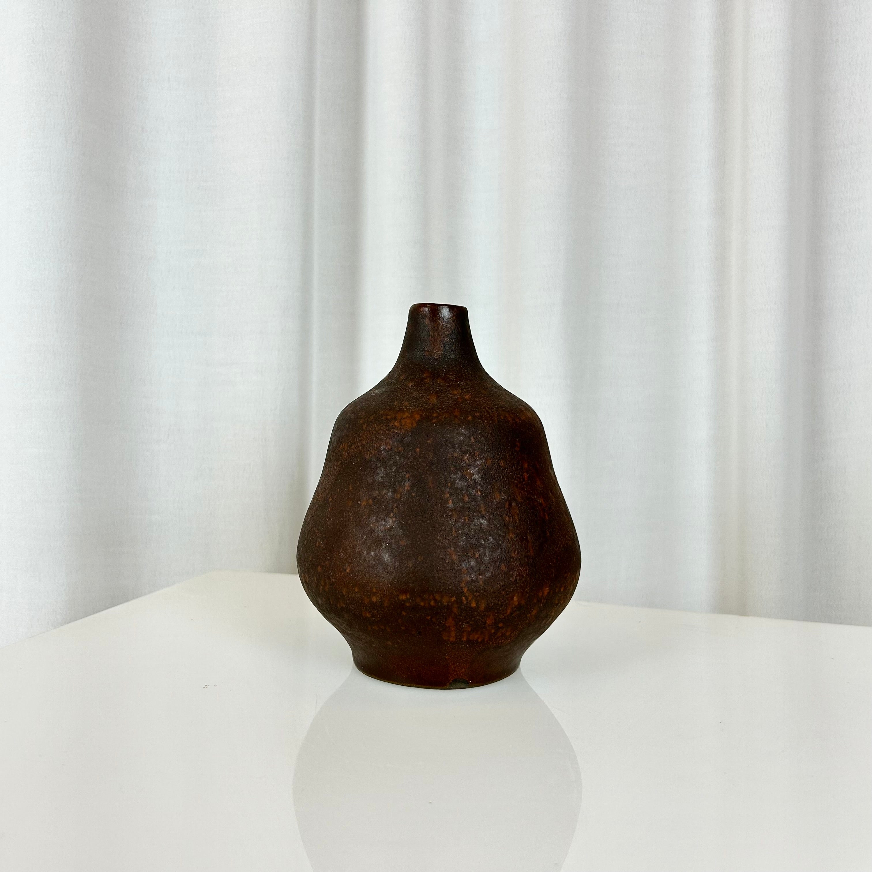 Small sculptural ceramic vase. Handmade, signed on the base, with organic rounded form and warm earthy glaze. A compact yet striking decorative piece.