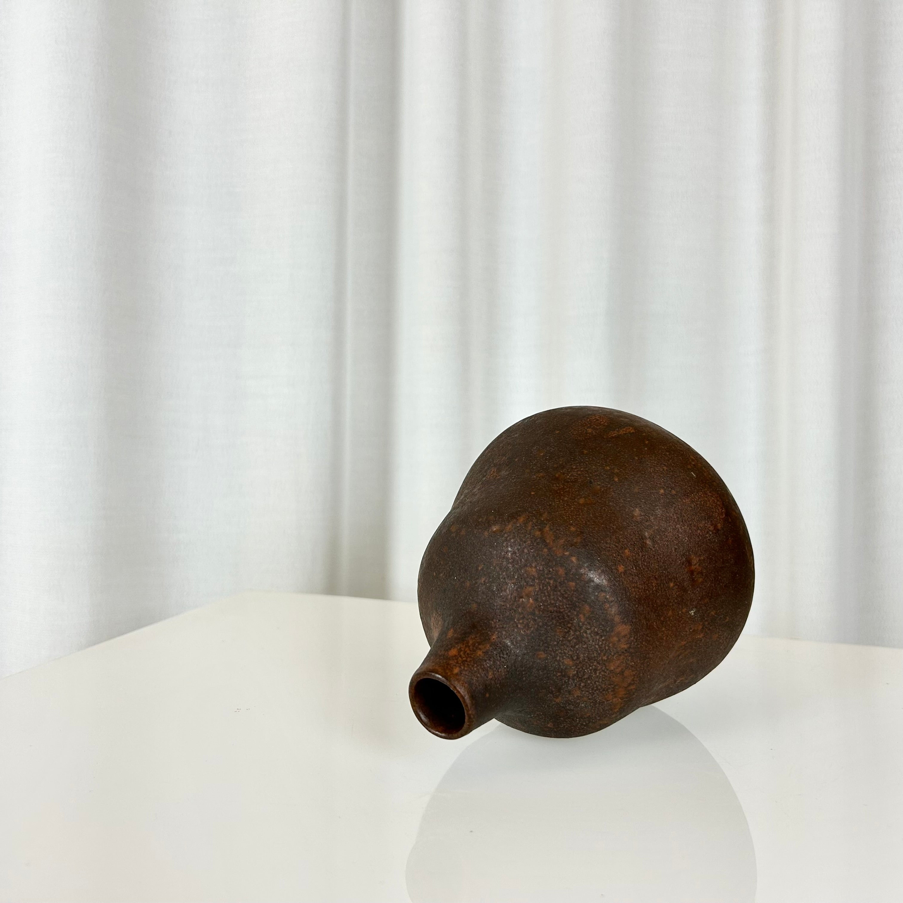 Small sculptural ceramic vase. Handmade, signed on the base, with organic rounded form and warm earthy glaze. A compact yet striking decorative piece.