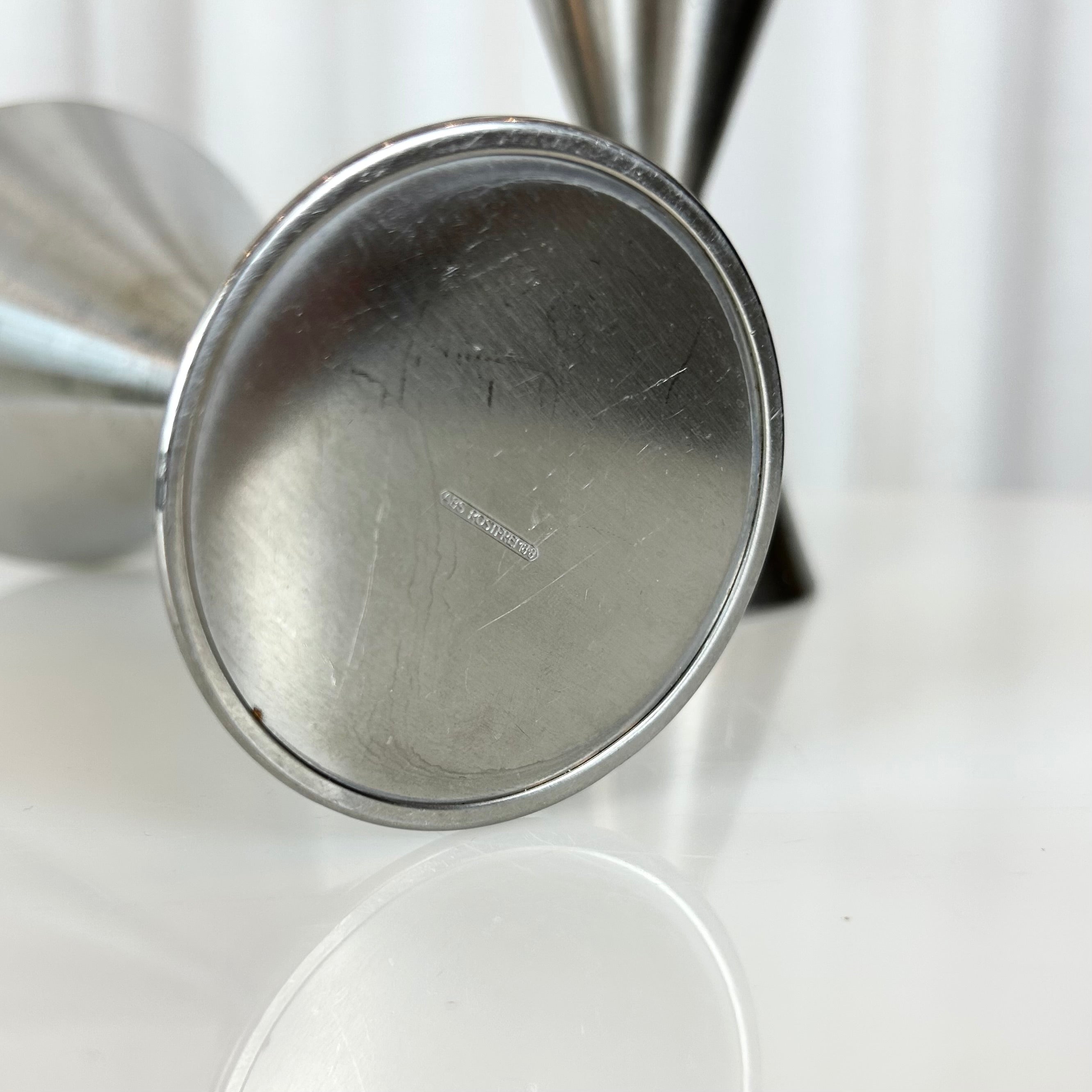 Closeup of a vintage DDR ABS stainless dessert glass in sculptural double-cone design