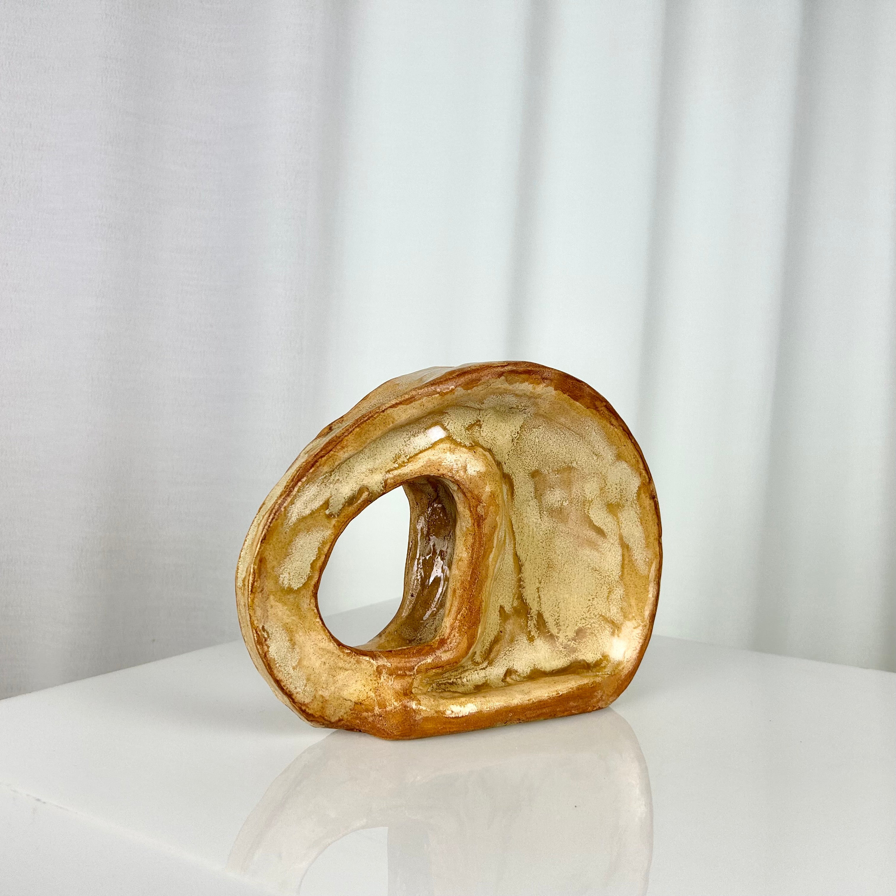 Vintage ceramic vase in sculptural circular form with ochre glaze