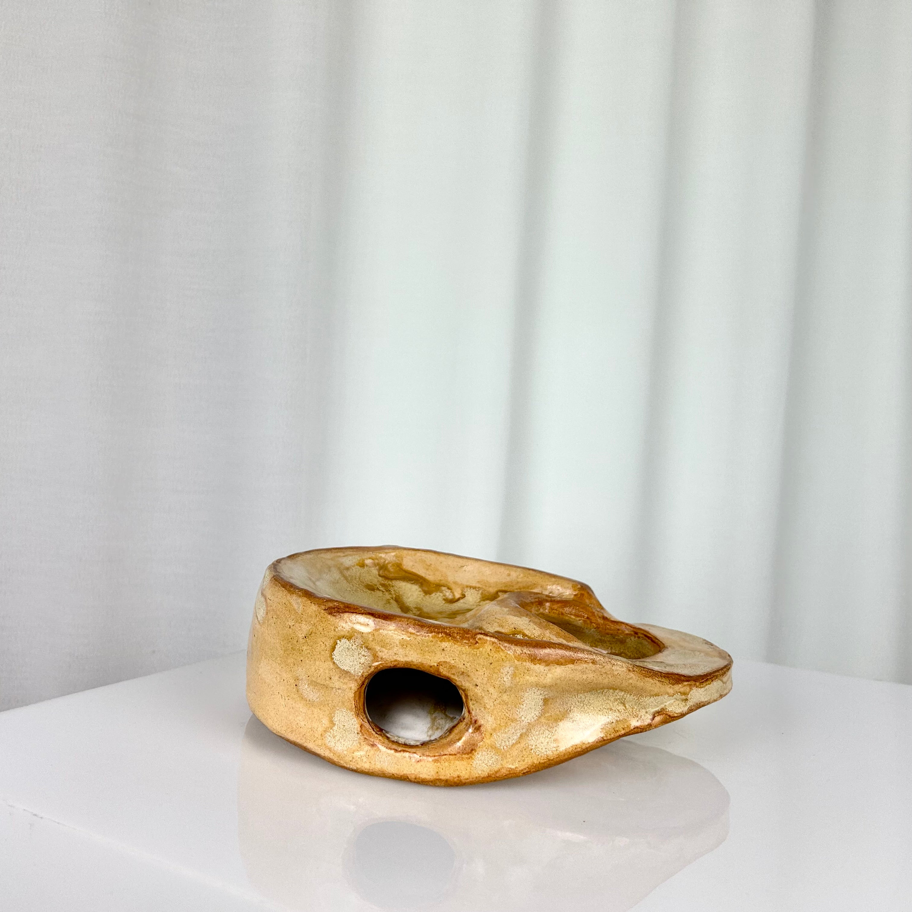 Vintage ceramic vase in sculptural circular form with ochre glaze