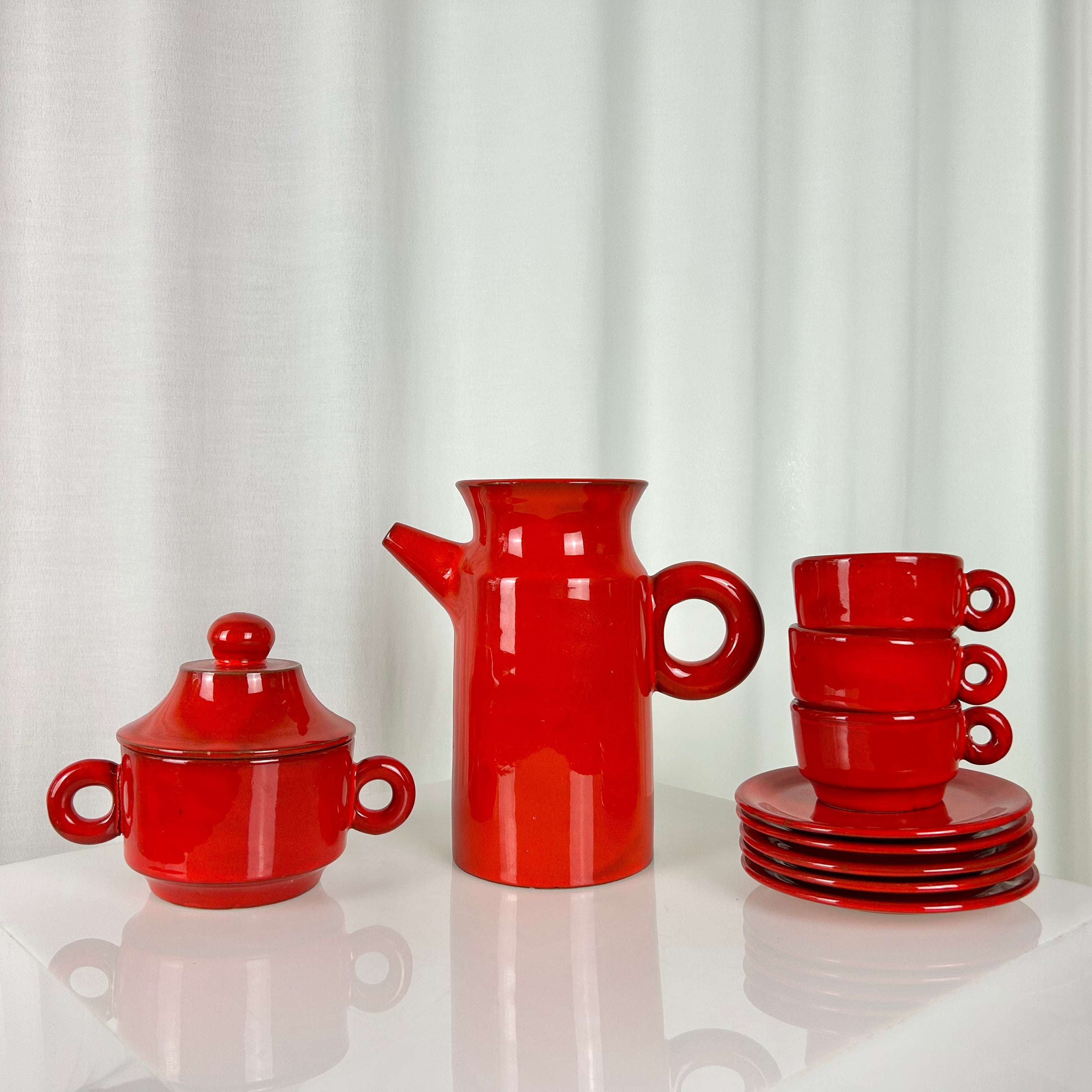 Vintage red ceramic coffee set from the 1970s with pot, sugar bowl, cups and saucers