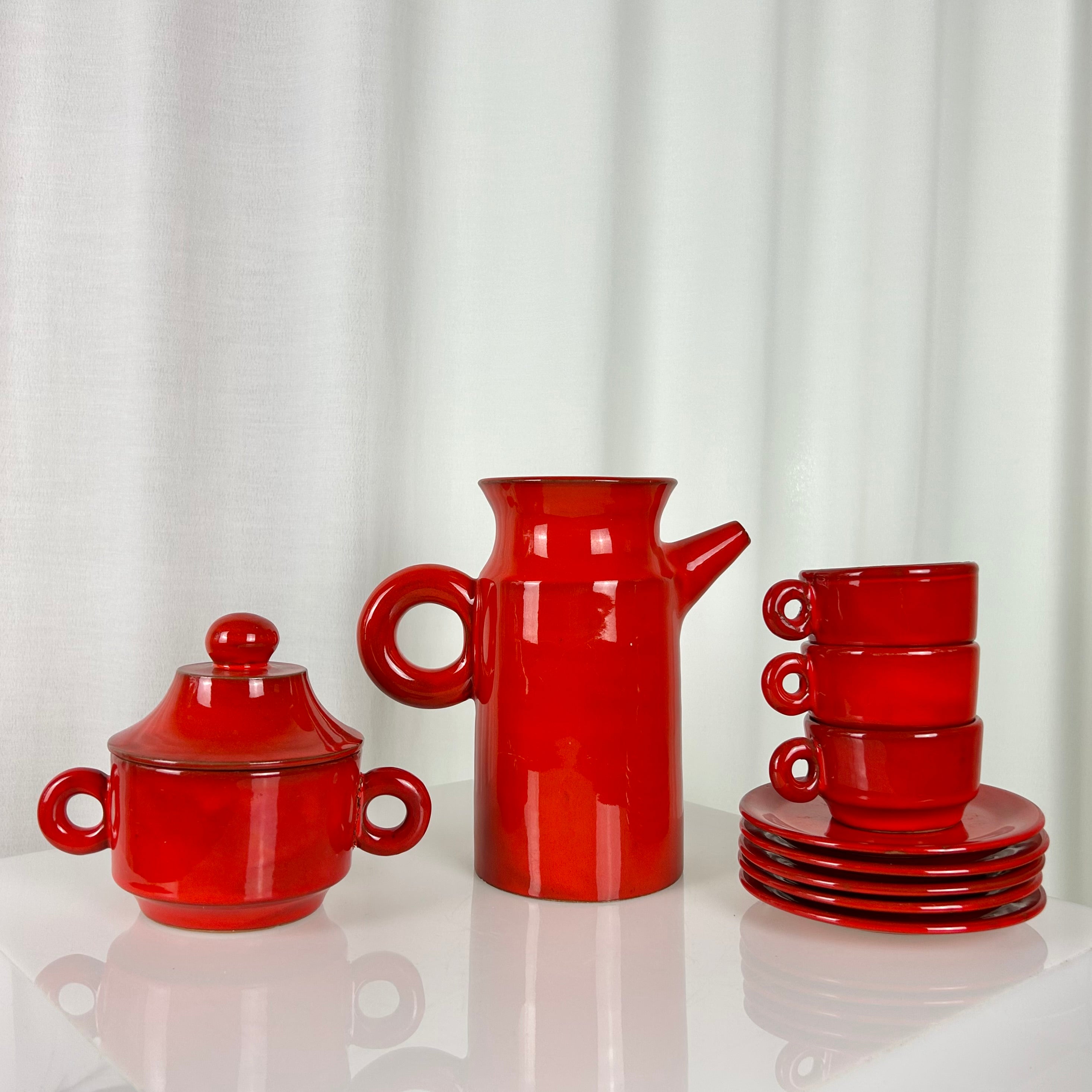 Vintage red ceramic coffee set from the 1970s with pot, sugar bowl, cups and saucers