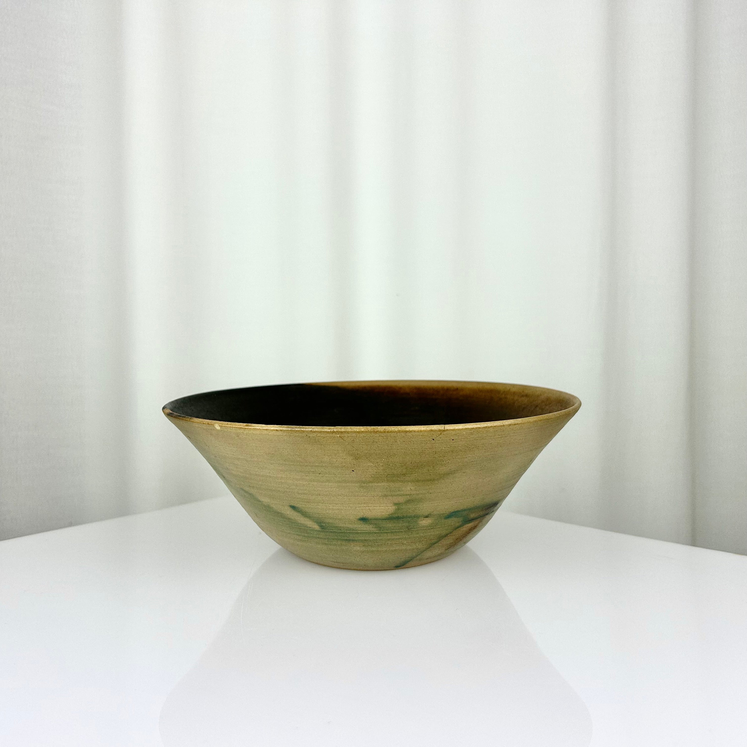 Vintage studio pottery hand-thrown bowl with dark beige and green glaze