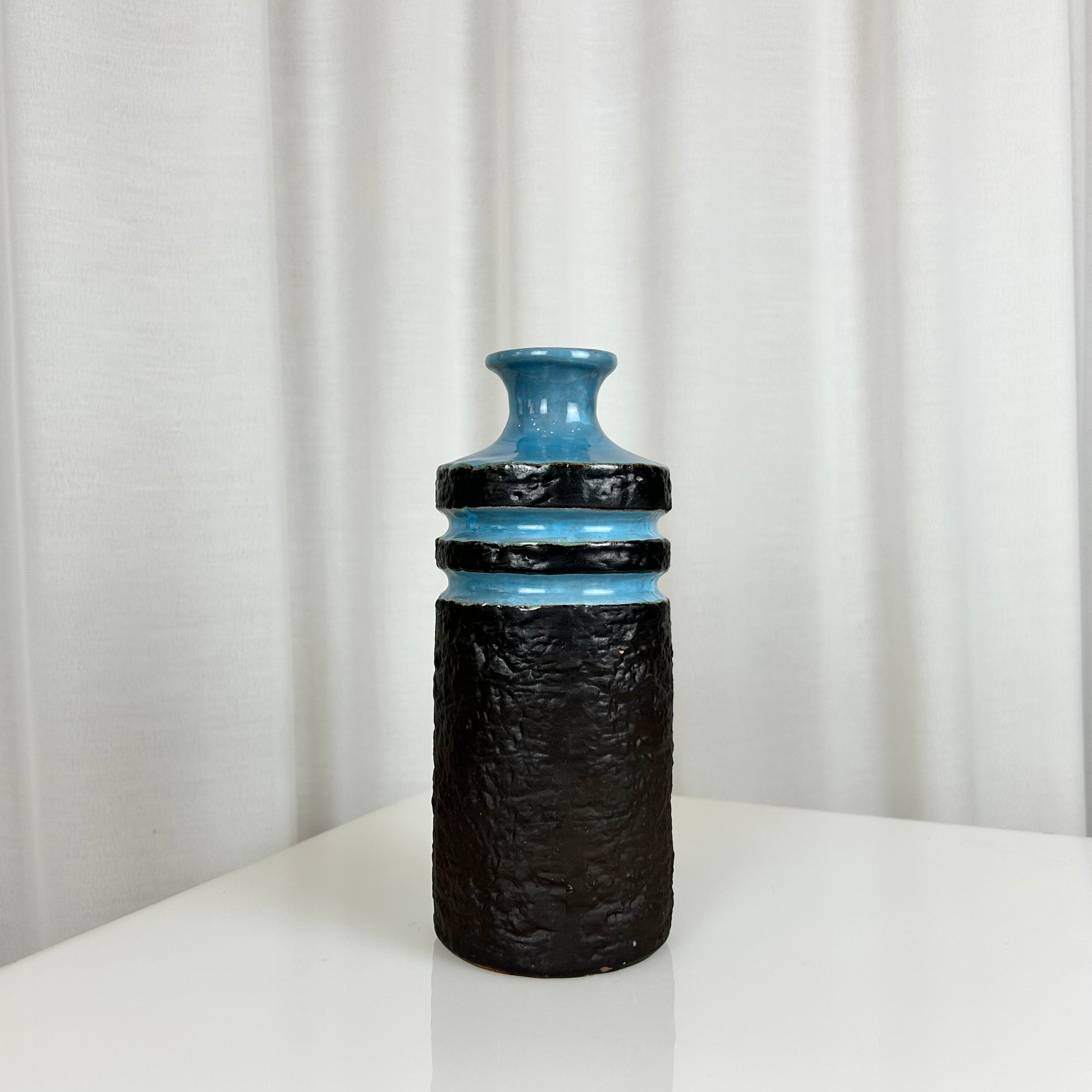 West German fat lava style ceramic vase with textured matte black body and glossy blue rings